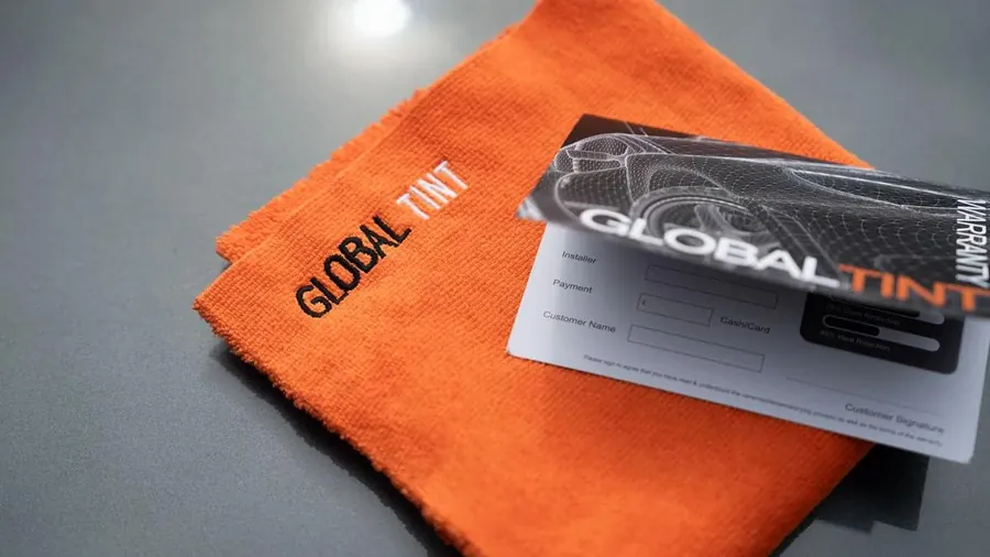 The Global Tint warranty card and aftercare cloth
