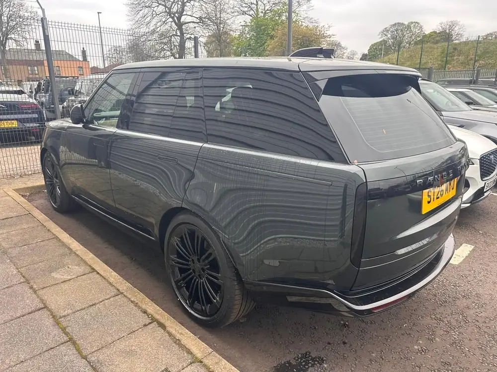 Dark grey Range Rover Autobiography viewed from the rear, with dark rear side windows and black wheels