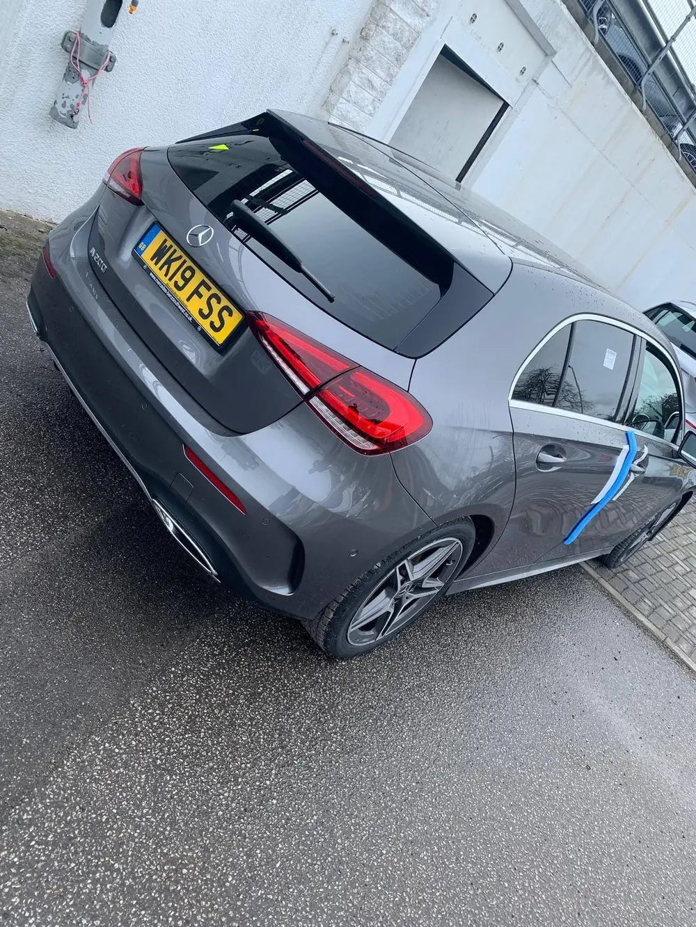 Grey Mercedes-Benz A200 hatchback with dark rear windows and rear windscreen, photographed at a tilted angle