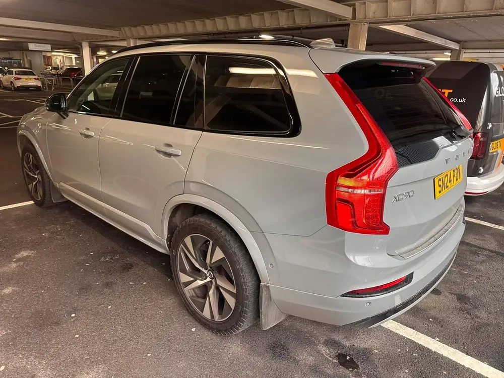 Light grey Volvo XC90 with dark rear side windows and rear windscreen.