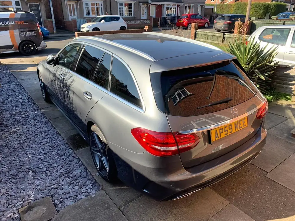 Silver estate with dark rear side windows and back windscreen, parked on a driveway.