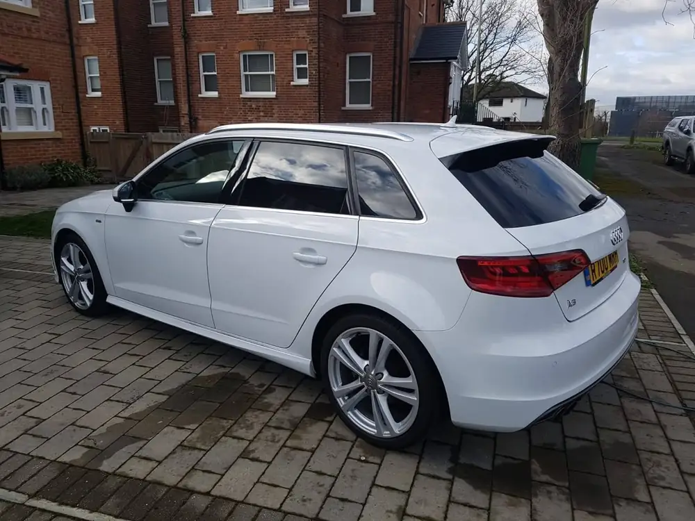 White Audi A3 with dark rear side windows and rear windscreen, parked on a paved driveway