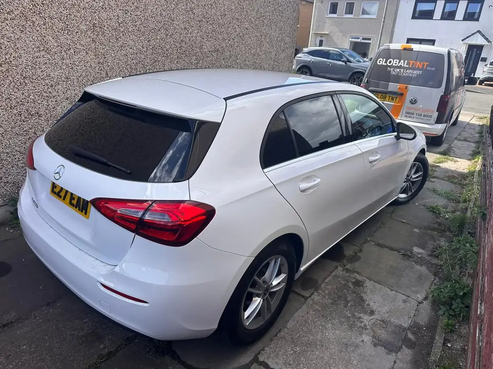 White Mercedes-Benz A-Class on a driveway, with a dark rear side window and rear windscreen.