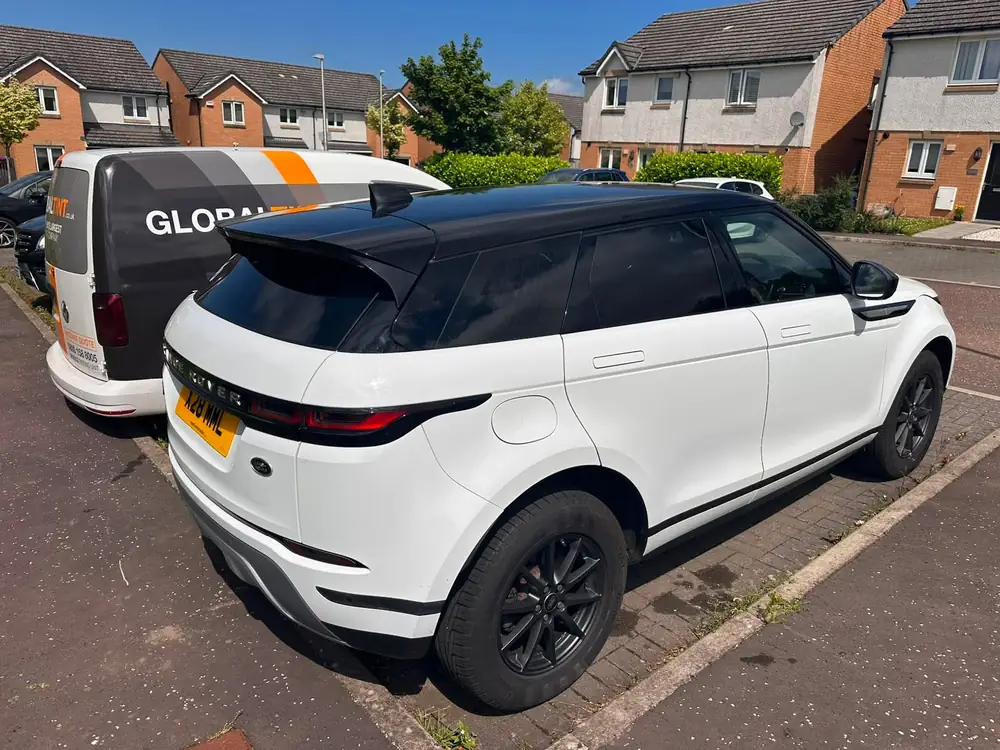 White Range Rover Evoque with a black roof, dark rear side windows and dark rear windscreen