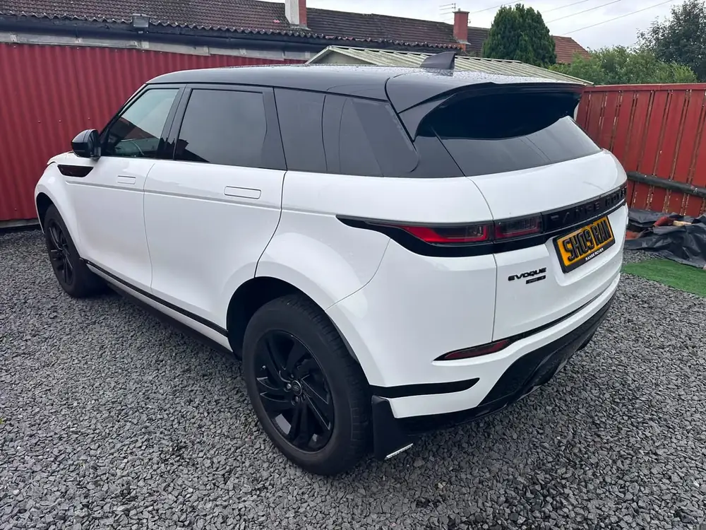 White Range Rover Evoque with dark rear side windows and back windscreen, parked on gravel.